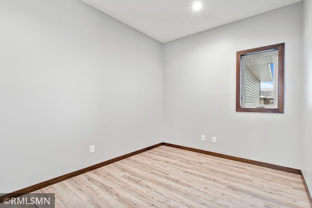 empty room featuring baseboards and wood finished floors