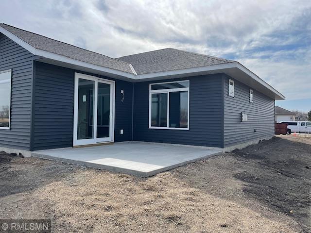 back of property featuring a patio area and a shingled roof