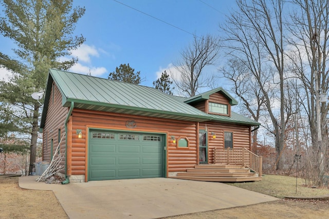 log home featuring a garage