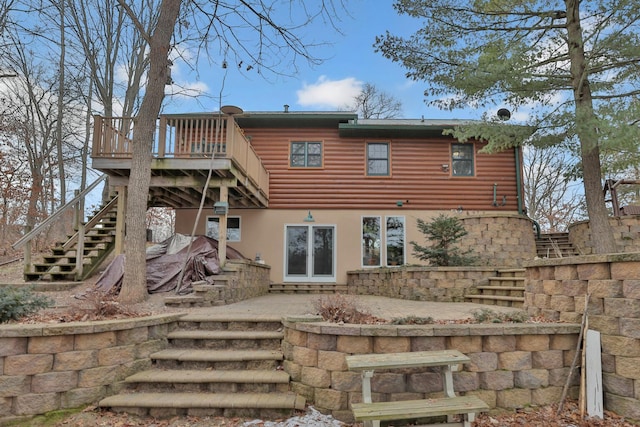 back of house with a deck and a patio area