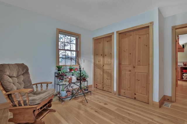 sitting room with light hardwood / wood-style flooring