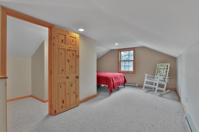 carpeted bedroom featuring a baseboard radiator and vaulted ceiling