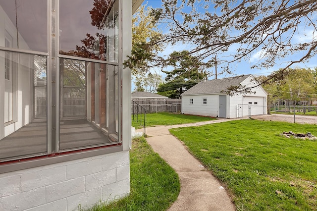 view of yard featuring a garage and an outbuilding