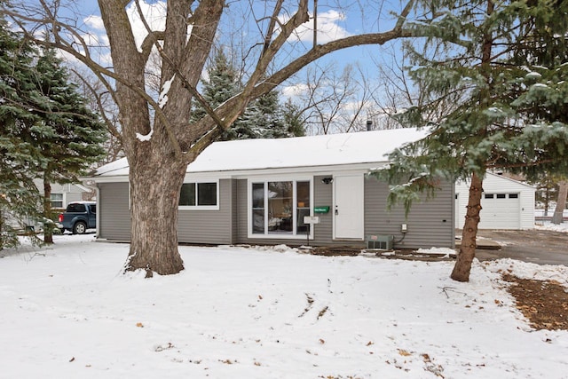 view of front of property with a garage and an outdoor structure