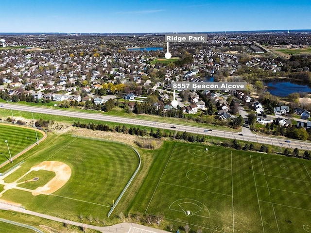 birds eye view of property with a water view and a residential view