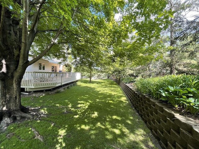 view of yard featuring fence and a deck