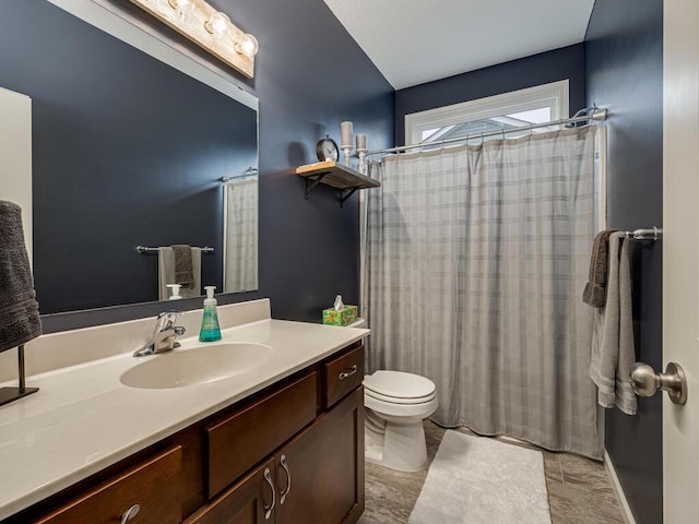 bathroom featuring a shower with curtain, vanity, and toilet