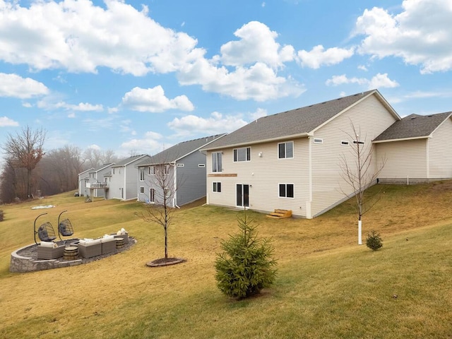 rear view of house featuring a lawn and an outdoor living space