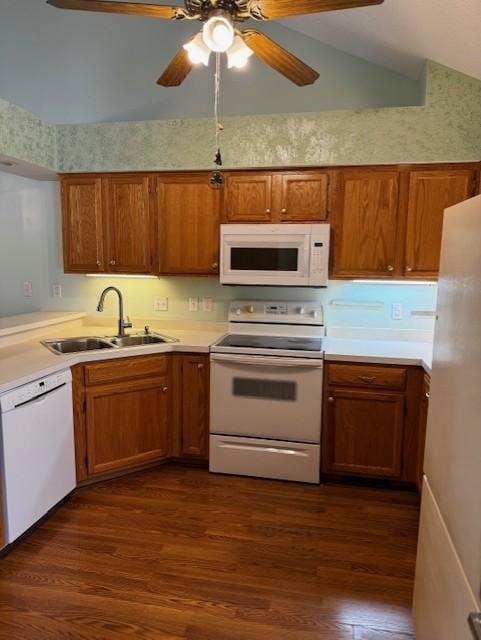 kitchen with ceiling fan, sink, dark wood-type flooring, lofted ceiling, and white appliances