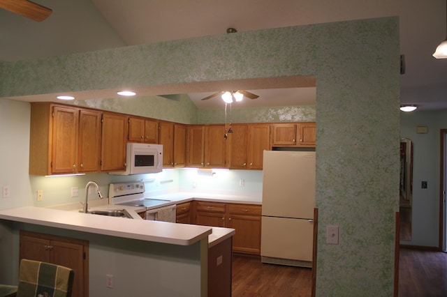 kitchen featuring vaulted ceiling, kitchen peninsula, sink, and white appliances