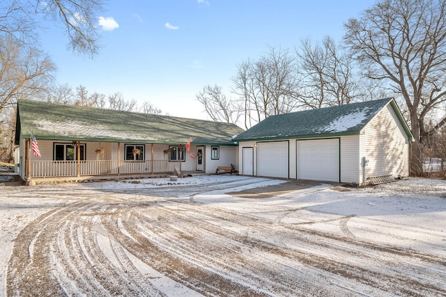 ranch-style home featuring a porch and a garage