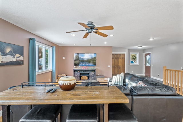 dining area with ceiling fan and a textured ceiling