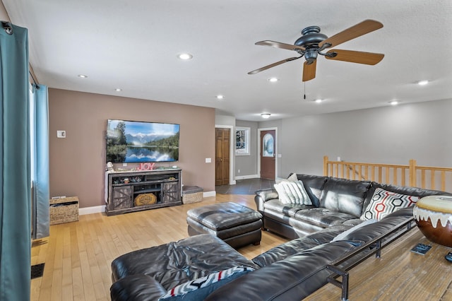 living room with ceiling fan and wood-type flooring