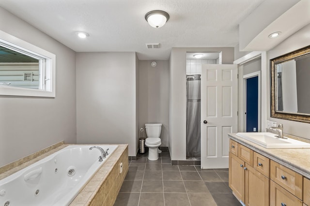 full bathroom with a textured ceiling, vanity, plus walk in shower, tile patterned flooring, and toilet