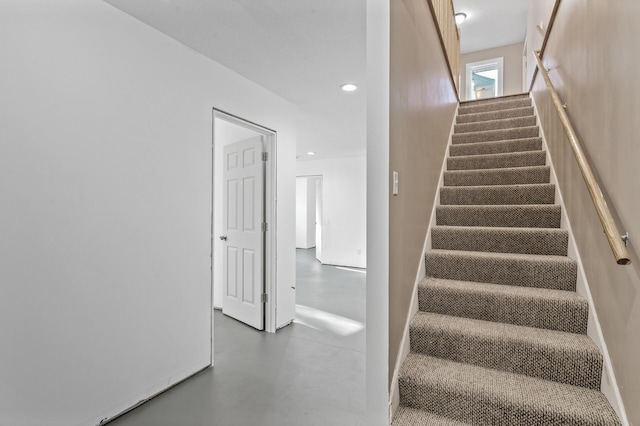 stairway with concrete flooring