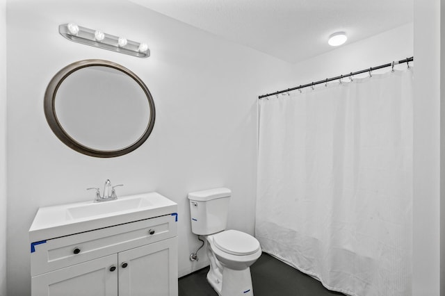 bathroom with vanity, a textured ceiling, and toilet