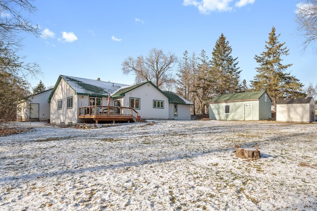 rear view of house with a shed and a wooden deck