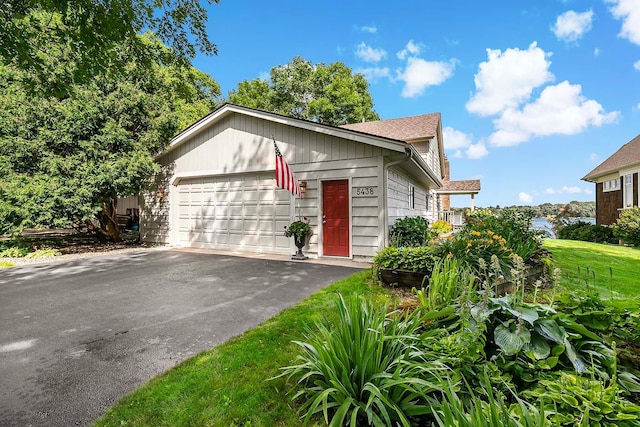 view of front of property with a front lawn and a garage