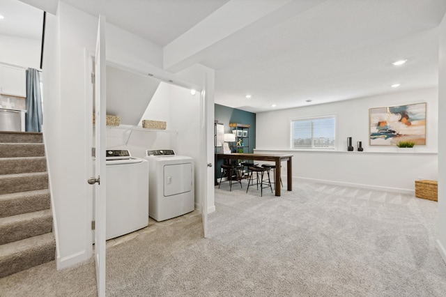 laundry room with washing machine and dryer and light colored carpet