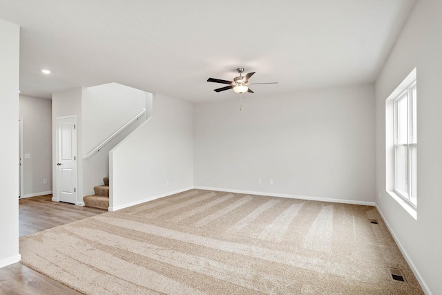 empty room featuring ceiling fan and light hardwood / wood-style flooring