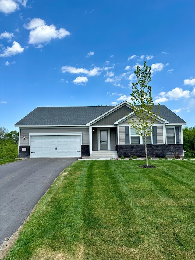 ranch-style house featuring a front yard and a garage