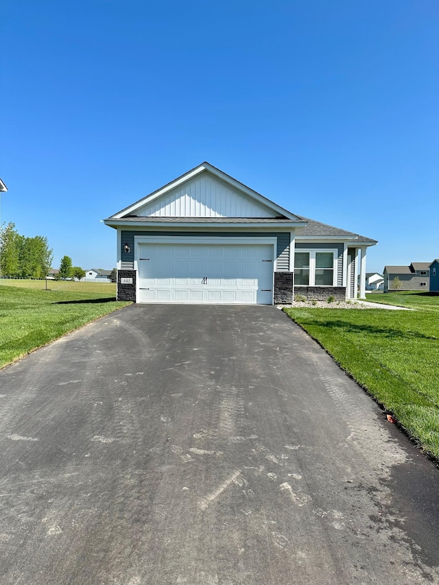 single story home with a garage and a front yard