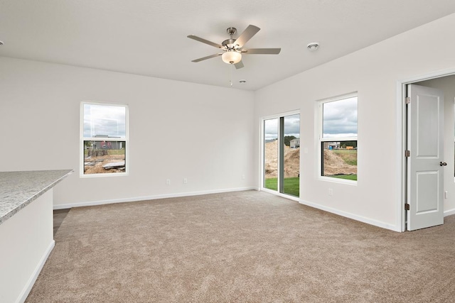 unfurnished living room with ceiling fan and carpet floors