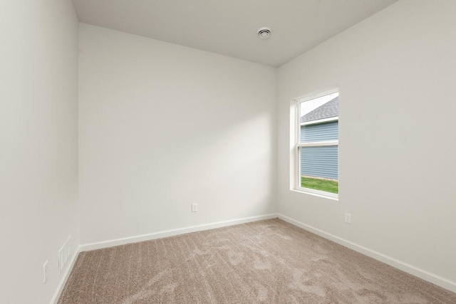 unfurnished room featuring light colored carpet