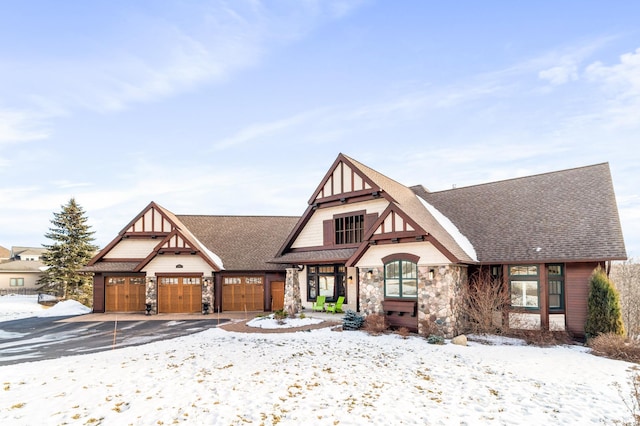 tudor-style house featuring a garage