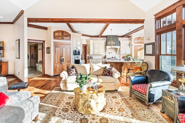 living room featuring light wood-type flooring, ornamental molding, and an inviting chandelier