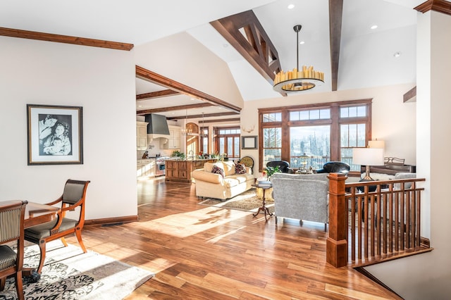 living room with a chandelier, wood-type flooring, high vaulted ceiling, and beam ceiling