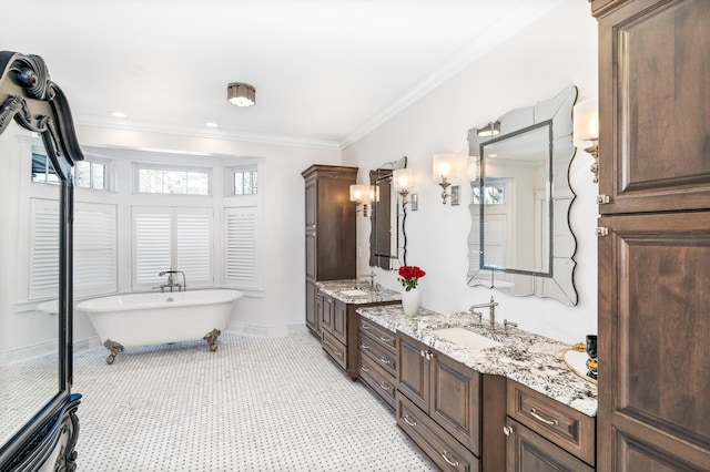 bathroom featuring crown molding, a bathtub, vanity, and tile patterned flooring