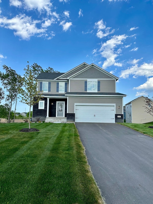 view of front facade featuring a garage and a front lawn