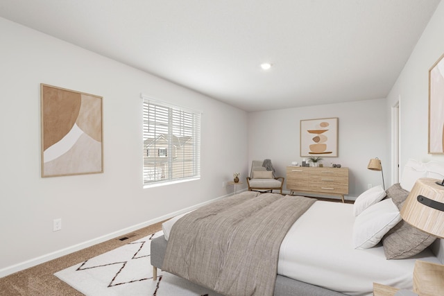 carpeted bedroom with visible vents and baseboards