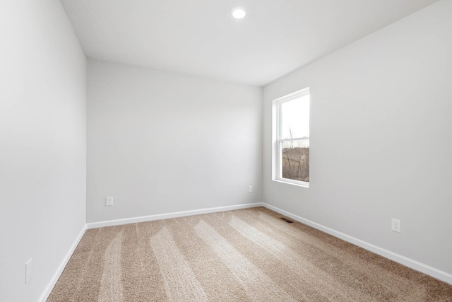 carpeted empty room with recessed lighting, visible vents, and baseboards