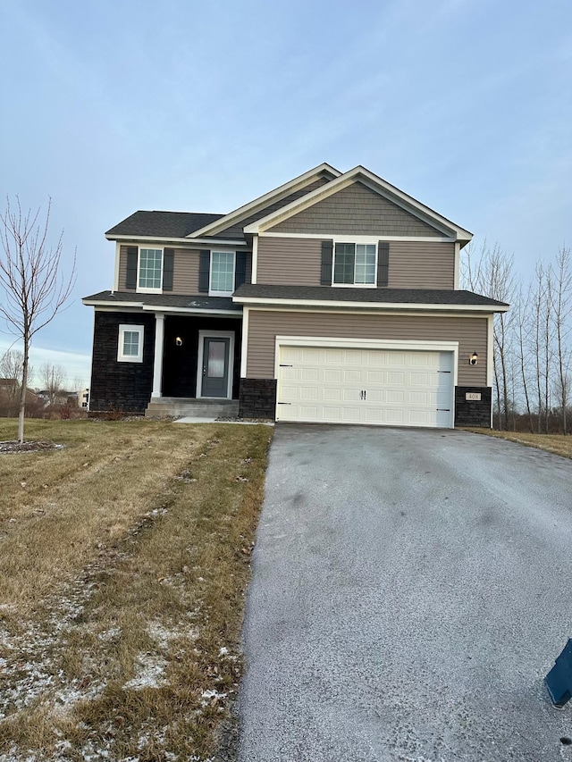 view of front facade featuring a garage and aphalt driveway