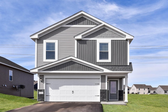 view of front of home with a front yard and a garage