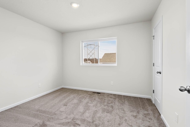 spare room with light colored carpet