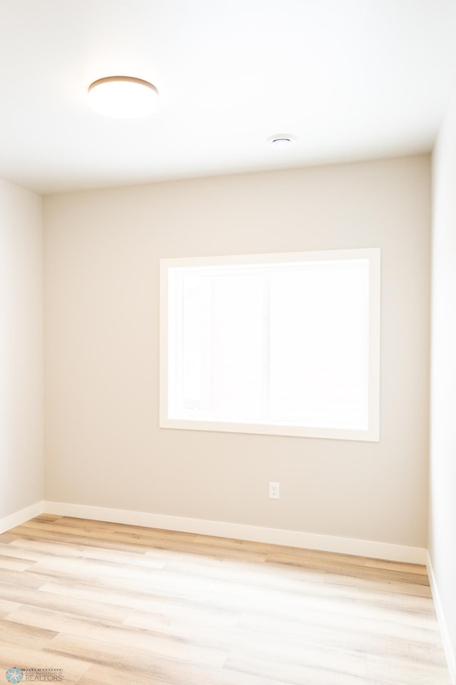 empty room with a healthy amount of sunlight and light wood-type flooring