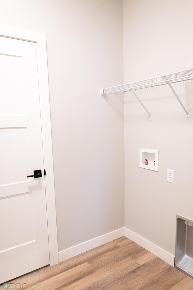 washroom featuring hookup for a washing machine and hardwood / wood-style floors