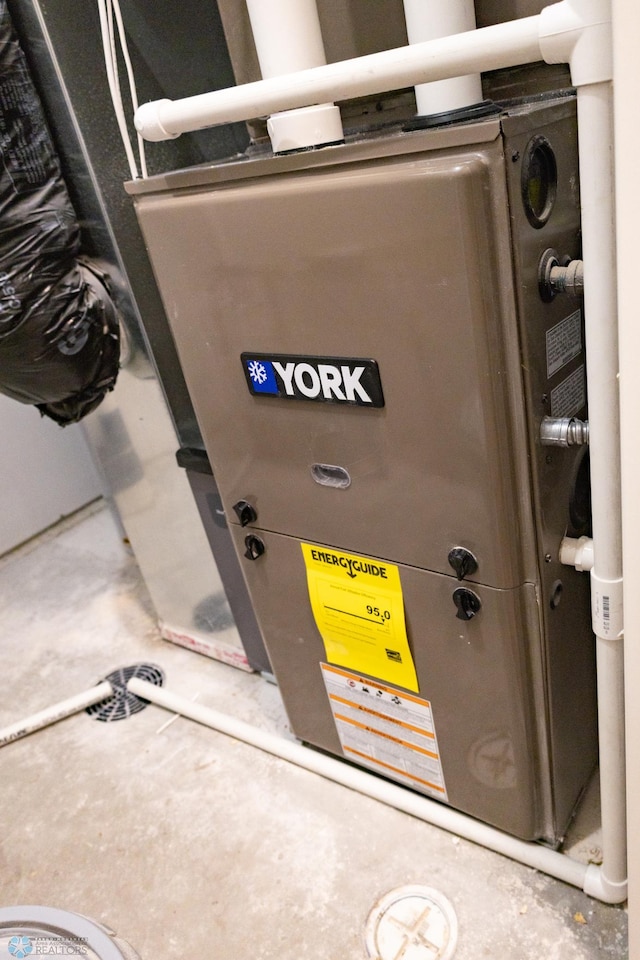 utility room featuring heating unit