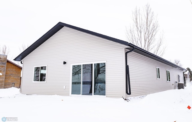 snow covered property with cooling unit