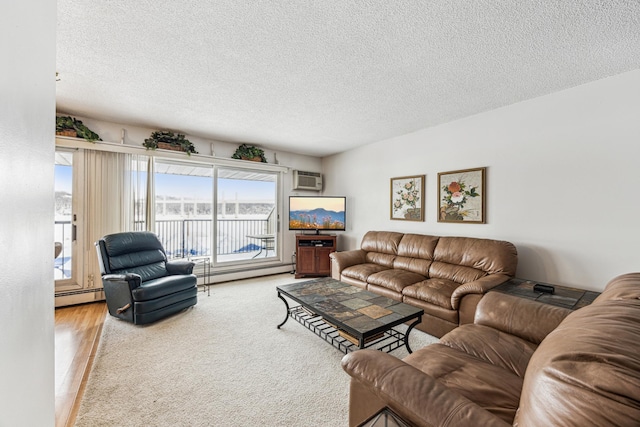 living room with an AC wall unit, a baseboard heating unit, hardwood / wood-style floors, and a textured ceiling