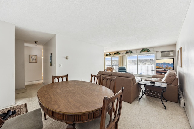 dining room with a textured ceiling and an AC wall unit