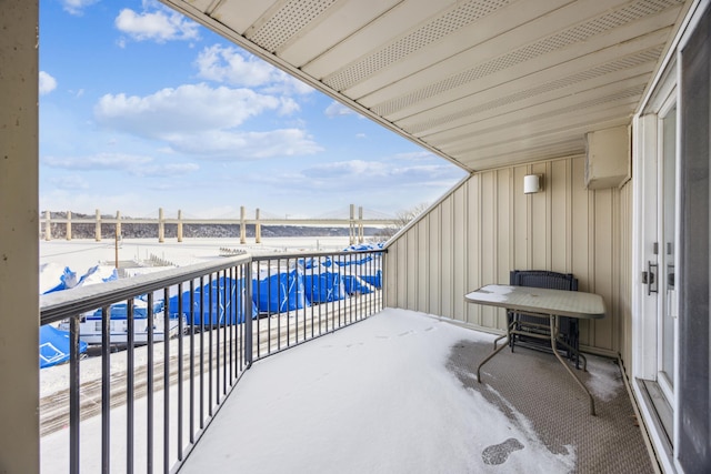 view of snow covered back of property