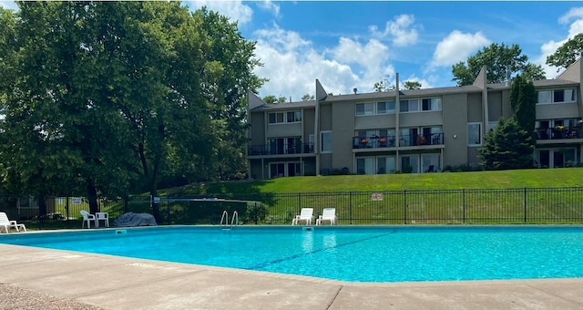 view of swimming pool featuring a patio and a lawn