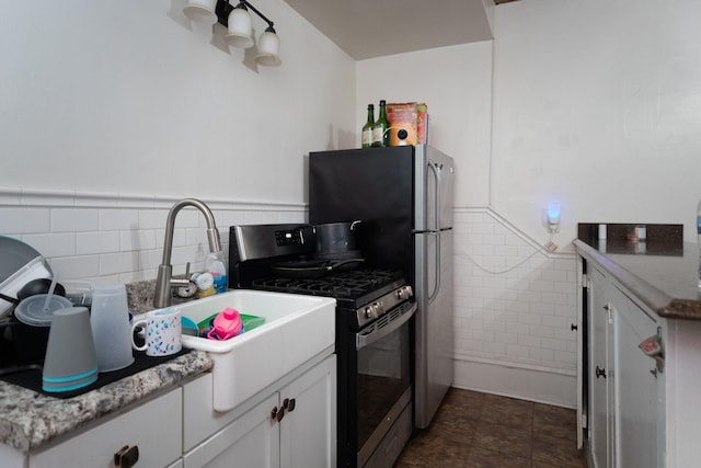 kitchen featuring white cabinetry, stainless steel appliances, and light stone counters