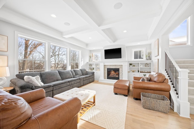 living room with coffered ceiling, light wood-type flooring, and beam ceiling