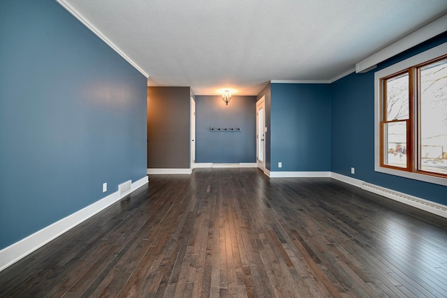 spare room featuring dark wood-type flooring and ornamental molding