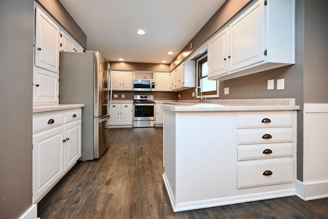 kitchen featuring white cabinets, dark hardwood / wood-style flooring, and stainless steel appliances